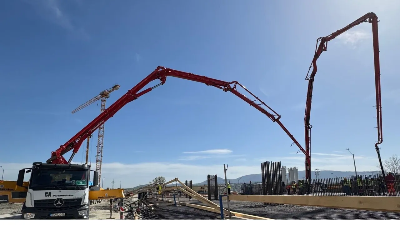 Large-scale concreting under a bright blue sky.