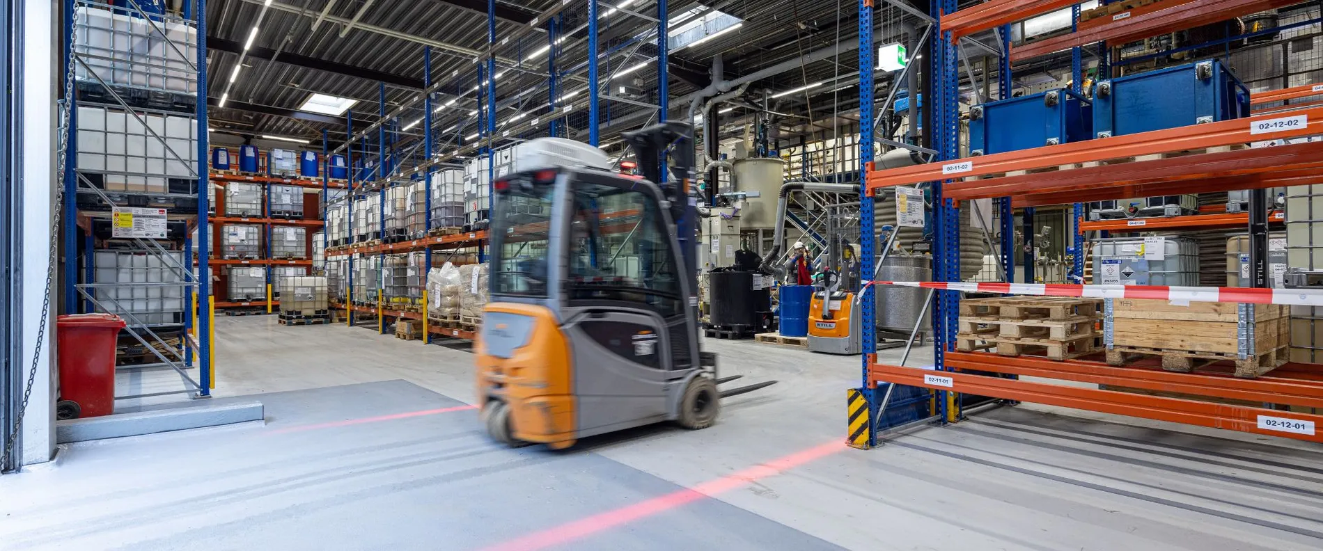 A forklift is driving through a warehouse.
