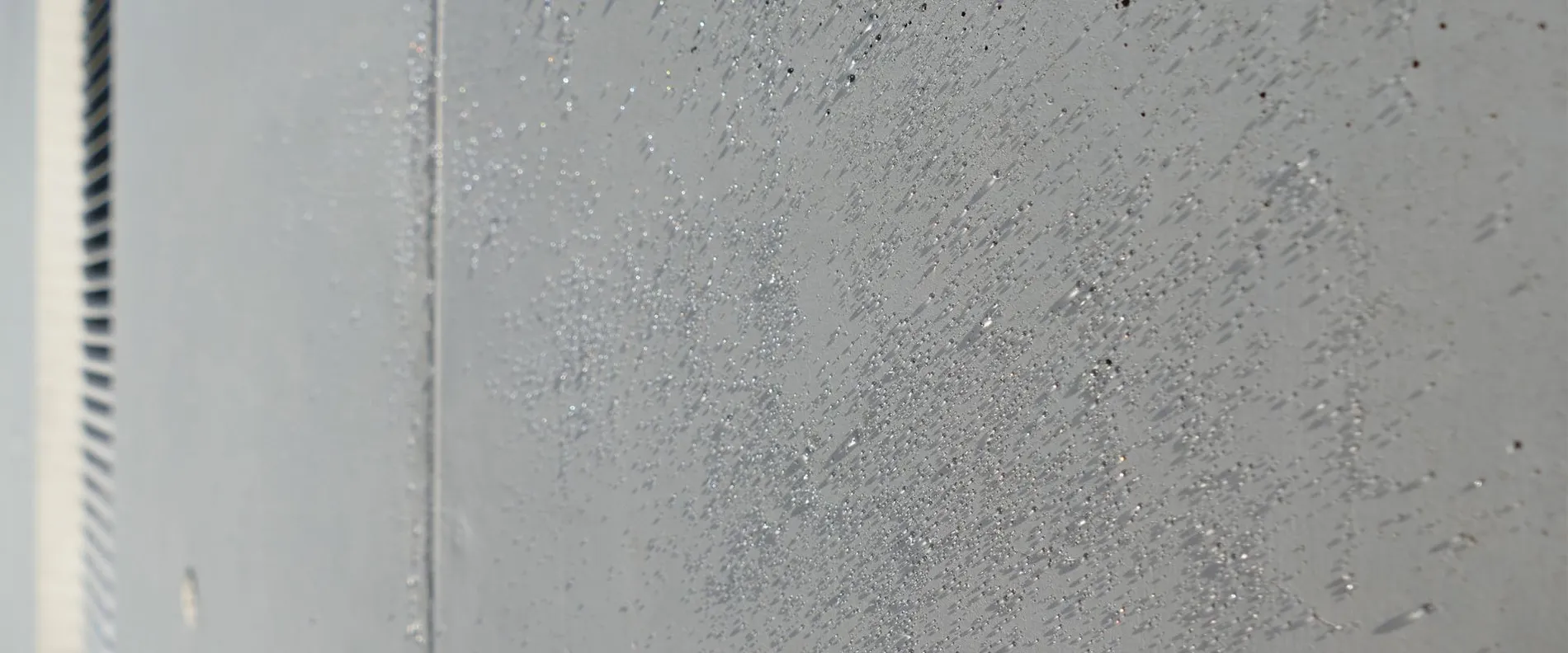 Water beads up from a concrete surface