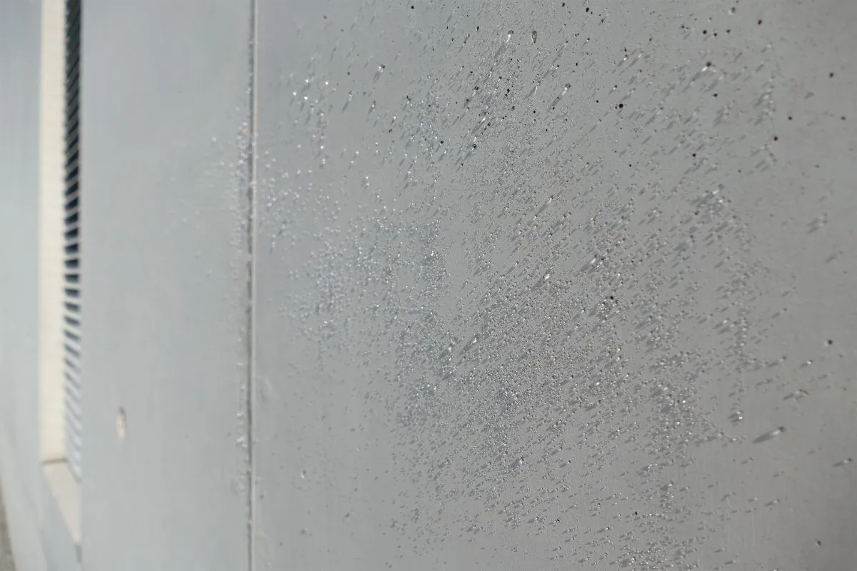 Water beads up from a concrete surface