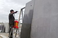 A man is applying a hydrophobic coating to concrete.