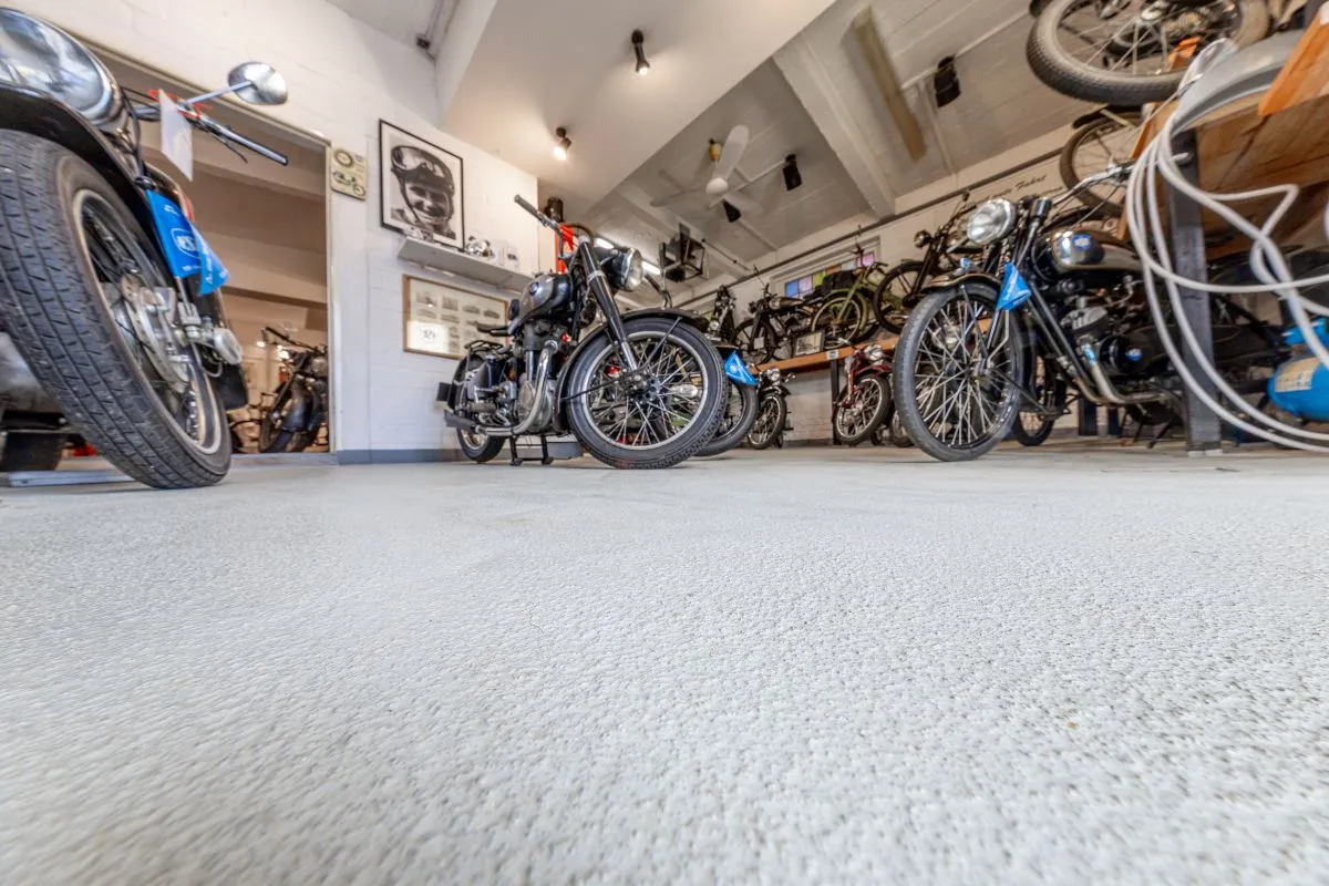 A view inside a room filled with motorbikes.