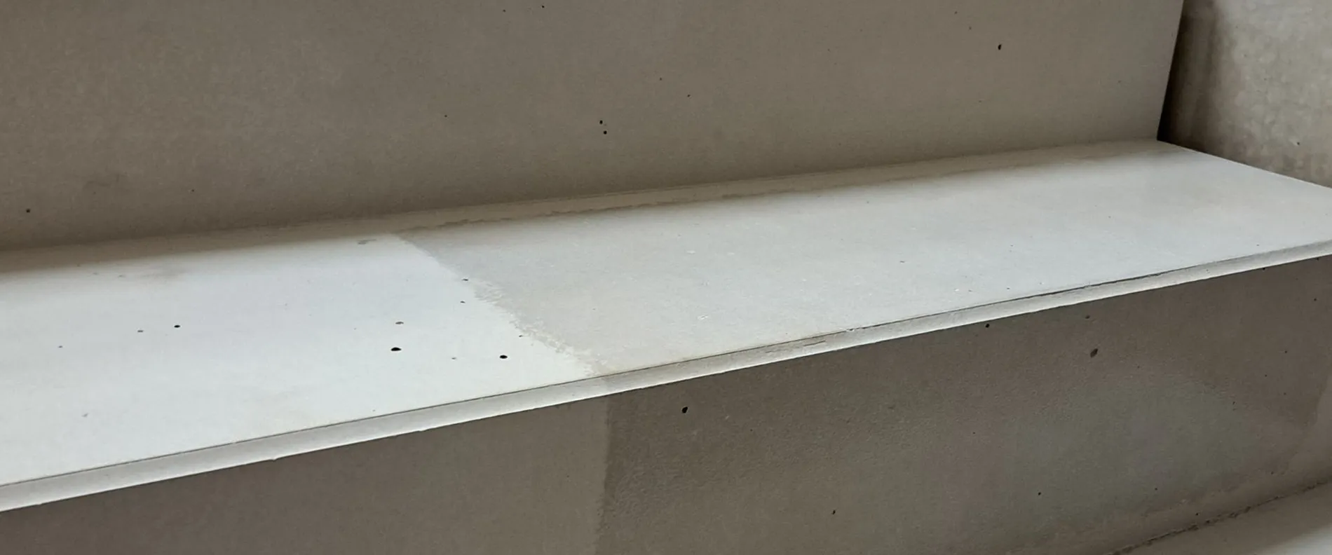 View of a set of stairs. One side is applied with MC-Floor Finish AC.