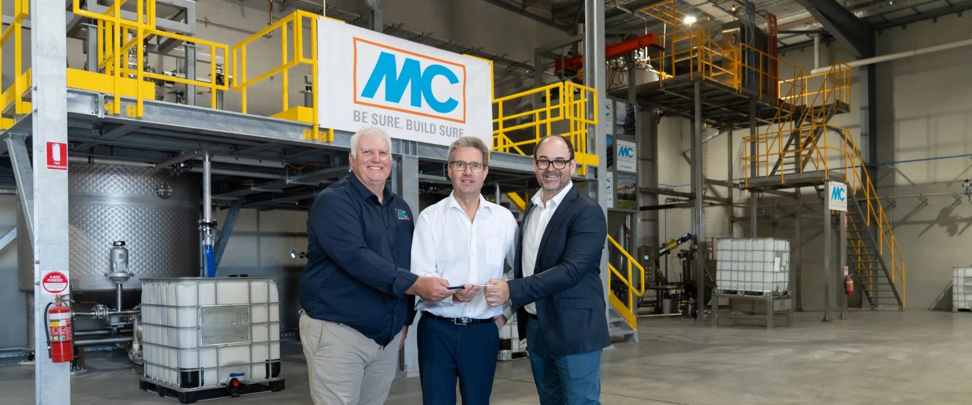 The photo shows Darren Maguire, Operations Manager at MC-Bauchemie Australia, Dr. Ekkehard zur Mühlen, Managing Director of the MC Group, and Jason Bolt, General Manager of MC-Bauchemie Australia, during the official opening of the new Adelaide production facility.
